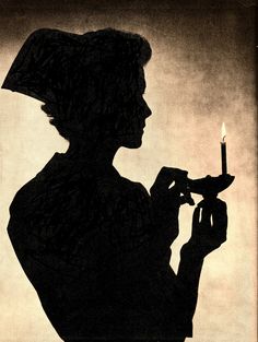 the silhouette of a woman holding a lit candle in one hand and wearing a hat on top of her head