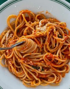 a white plate topped with pasta and sauce