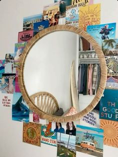 a mirror that is hanging on the wall with pictures and books all over it's frame