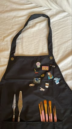 a black bag filled with pins and other items