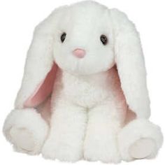 a white stuffed rabbit sitting up against a white background