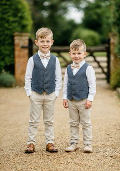 two young boys wearing vests and bow ties