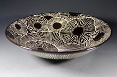 a black and white bowl sitting on top of a table