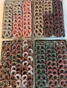 six trays filled with assorted donuts and pretzels in different colors