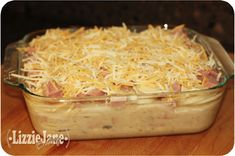 a casserole dish with ham and cheese in it sitting on a table top