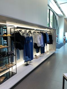 an empty store with clothes and shoes on display