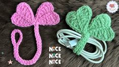 two crocheted shamrocks are sitting next to each other on a furry surface