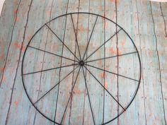 a wire wheel sitting on top of a wooden floor