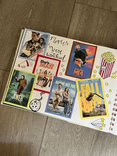 an open notebook with various movie posters on it