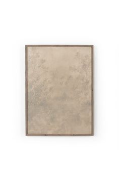 a painting hanging on the wall in front of a white wall with a brown frame