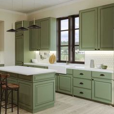 a kitchen with green cabinets and white counter tops