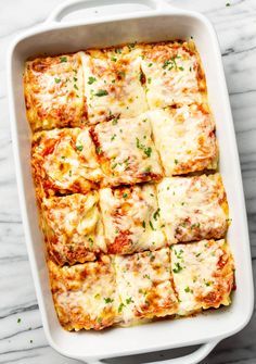 square lasagna casserole in a white dish on a marble countertop