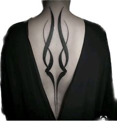 the back of a woman's neck with an intricate tattoo design on her upper part