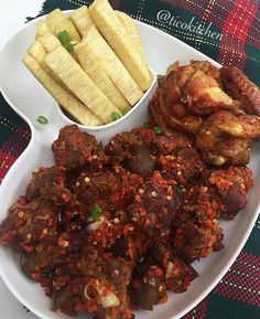 a white plate topped with meat and vegetables