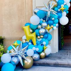 a balloon arch with stars and balloons attached to it