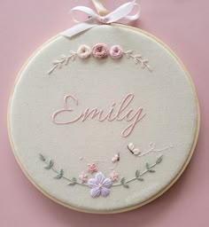 Pastel coloured 8 inch hand embroidered hoop. EMILY name in pastel pink Embroidery Name With Flowers, Embroidered Hoops Ideas, Embroidery Patterns Name, Embroidery Name Patterns, Embroidered Names Hand Embroidery, Embroidery Designs Names, Embroidery For Nursery, Name Embroidery Designs, Newborn Baby Embroidery Hoop