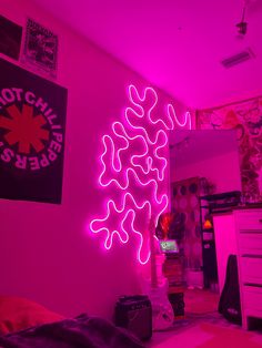 a room with pink walls and neon lights