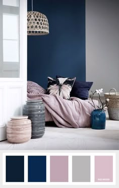 a living room with blue walls and white trimmings, including pink and grey accents