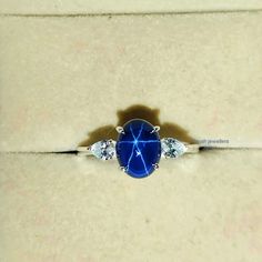 a blue ring with three diamonds on it