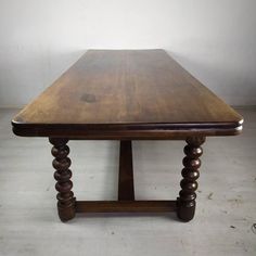 a large wooden table sitting on top of a white floor