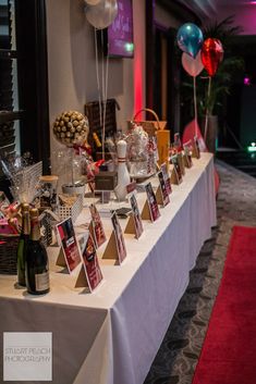 a table with wine bottles and balloons on it