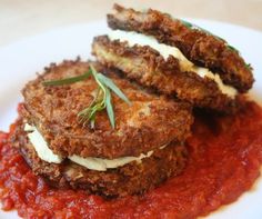 two fried meat patties with tomato sauce on a white plate