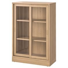 a wooden bookcase with glass doors on the front and bottom shelves in light wood