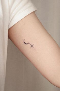 a woman's arm with a small star and crescent tattoo on the left inner arm