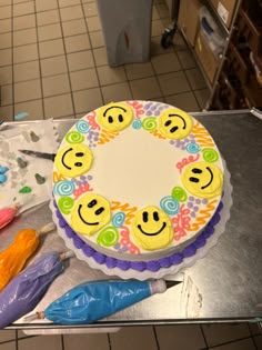 a smiley face cake sitting on top of a table