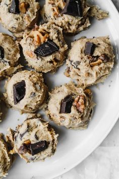 a white plate topped with cookies covered in chocolate