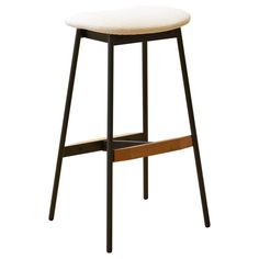 the backless stool is made from wood and has a white upholstered seat