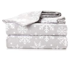 two sheets with snowflakes on them, one is grey and the other is white