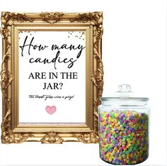 a jar filled with candy next to a sign that says how many candies are in the jar