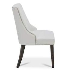 a white upholstered chair with wooden legs and nail - tipped trimmings