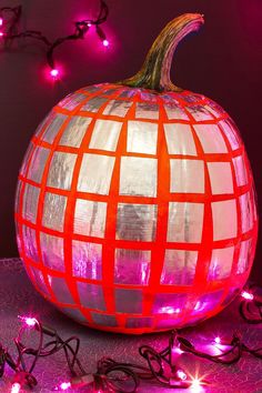 a lighted pumpkin sitting on top of a table