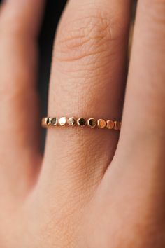 This stacking ring is perfect for mixing and matching! Either wear several at once or mix some in with your favorite rings for extra width and sparkle! This new version of the Bead Ring is slightly more durable than its predecessor! This listing is for ONE SINGLE ring.This ring is made out of 14K GOLD FILL metal.The finish is lightly faceted/hammered.* The photos show this new Mini Bead Ring style compared to our Original Bead Ring! Each Mini Bead Ring is individually cut, soldered and polished 14k Gold Faceted Stackable Rings, Stacking Rings Gold, Interlocking Ring, Dot Ring, Thick Ring, Single Ring, Flat Back Earrings, Stacking Ring Set, Hammered Rings