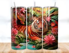 three metal tumbles with tiger and flowers on them