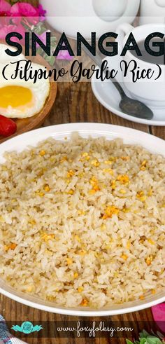 an egg and rice dish in a white bowl on top of a wooden table with flowers