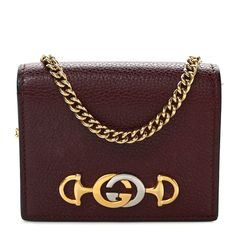 This is an authentic GUCCI Grainy Calfskin Zumi Chain Card Case Wallet in Vintage Bordeaux. This chic wallet is crafted of grained calfskin leather in burgundy. It features a polished gold and silver Gucci GG logo on the front and an optional gold chain strap. The front flap opens to a burgundy leather interior with card slots and a zipper pocket. This is a charming cardholder that is practical and chic, from Gucci! Wallet Vintage, Card Case Wallet, Gg Logo, Leather Interior, Gold And Silver, Chain Strap, Card Case, Gold Chain, Gold Chains