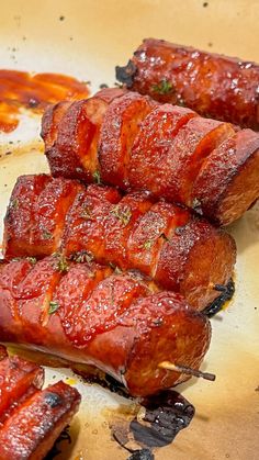 some bacon wrapped in sauce sitting on top of a cutting board