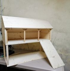 the unfinished shelf is sitting on top of the workbench, ready to be built