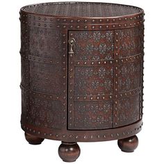 an ornate wooden cabinet with metal studs on the front and sides, sitting on casteors