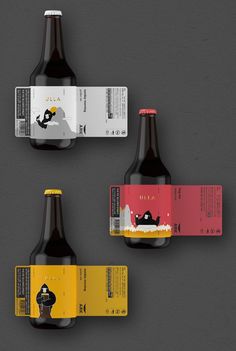 three beer bottles with labels on them sitting next to each other in front of a gray background