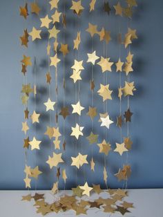 a merry and bright sign hanging from the side of a blue wall with gold stars