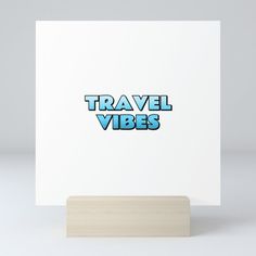 a white card with the words travel vibes printed in blue on it's front