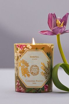 a candle that is next to a flower