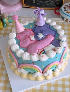 a birthday cake decorated with teddy bears and rainbows