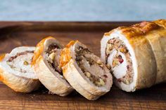 a meat filled pastry cut in half on a cutting board