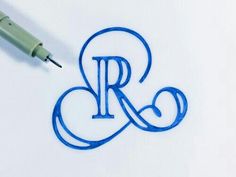 the letter r is drawn on paper with a fountain pen next to it and an eraser