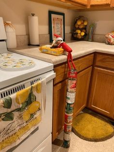 a kitchen with an oven, stove and yellow rug on the floor in front of it